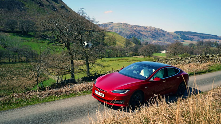 Tesla Model S 100D in red against a Lake District backdrop